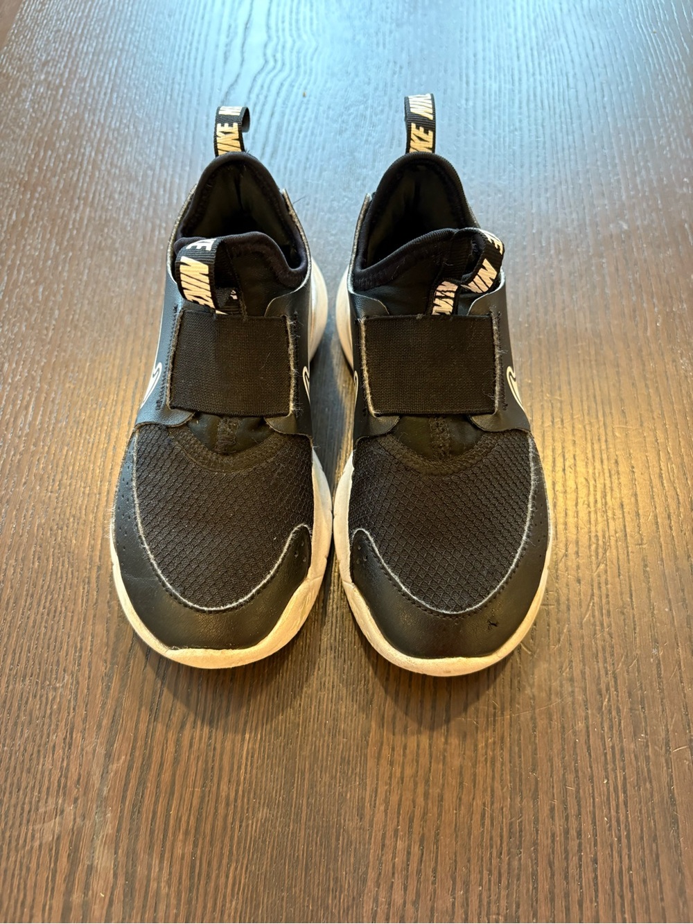 Nike Black Slip-On Athletic Shoes with White Soles and Logo Tabs